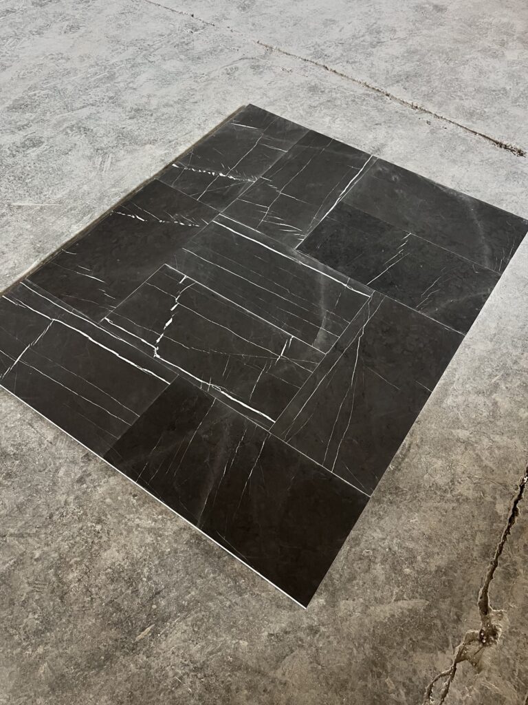 An image of dry laid 1.2 mm Pietra gray marble tiles on the ground